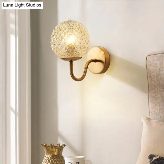Gold Textured Glass Ball Wall Sconce with brass curved arm and round backplate on Tampa Home & Garden Store