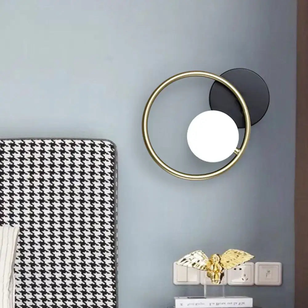 Gold ring industrial wall sconce with black backplate and white globe by Decorbites on Tampa Home & Garden Store
