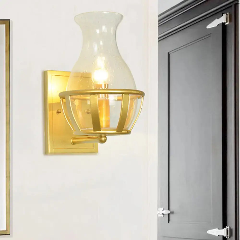 Gold clear glass wall lamp by Decorbites with brass backplate and cage shade on Tampa Home & Garden Store