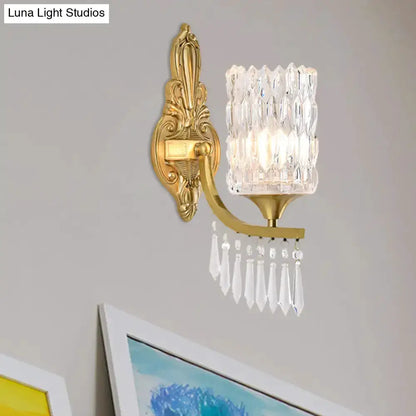 Postmodern gold column crystal wall lamp with crystal shade and hanging prisms on wall on Tampa Home & Garden Store
