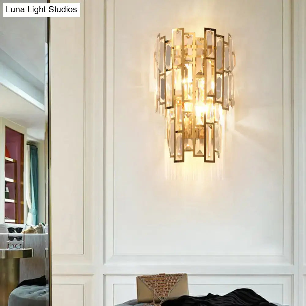 Decorbites gold crystal curved sconce on white paneled wall on Tampa Home & Garden Store