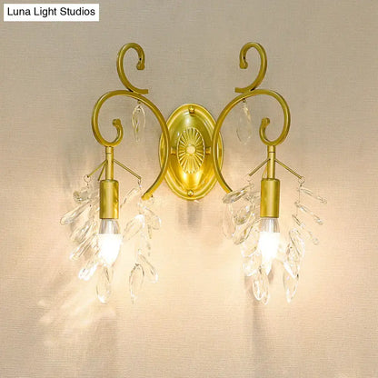 Gold curve crystal sconce with twin arms and hanging prisms on Tampa Home & Garden Store
