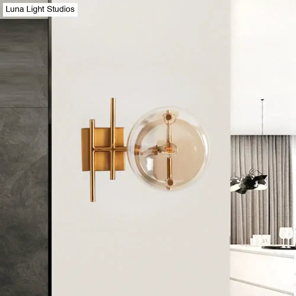 Gold double ball glass sconce by Decorbites with brass frame and clear glass globe on wall on Tampa Home & Garden Store