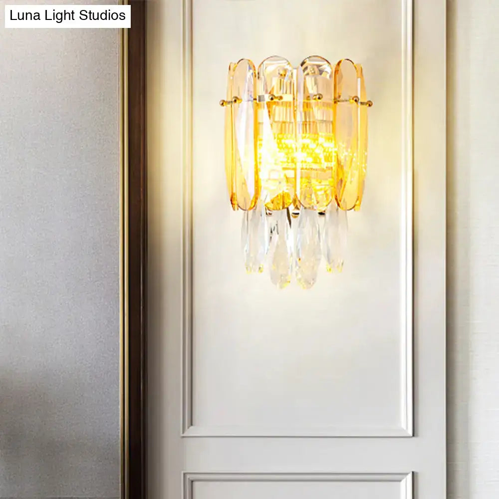 Gold faceted crystal sconce with hanging prisms and warm amber glow on Tampa Home & Garden Store
