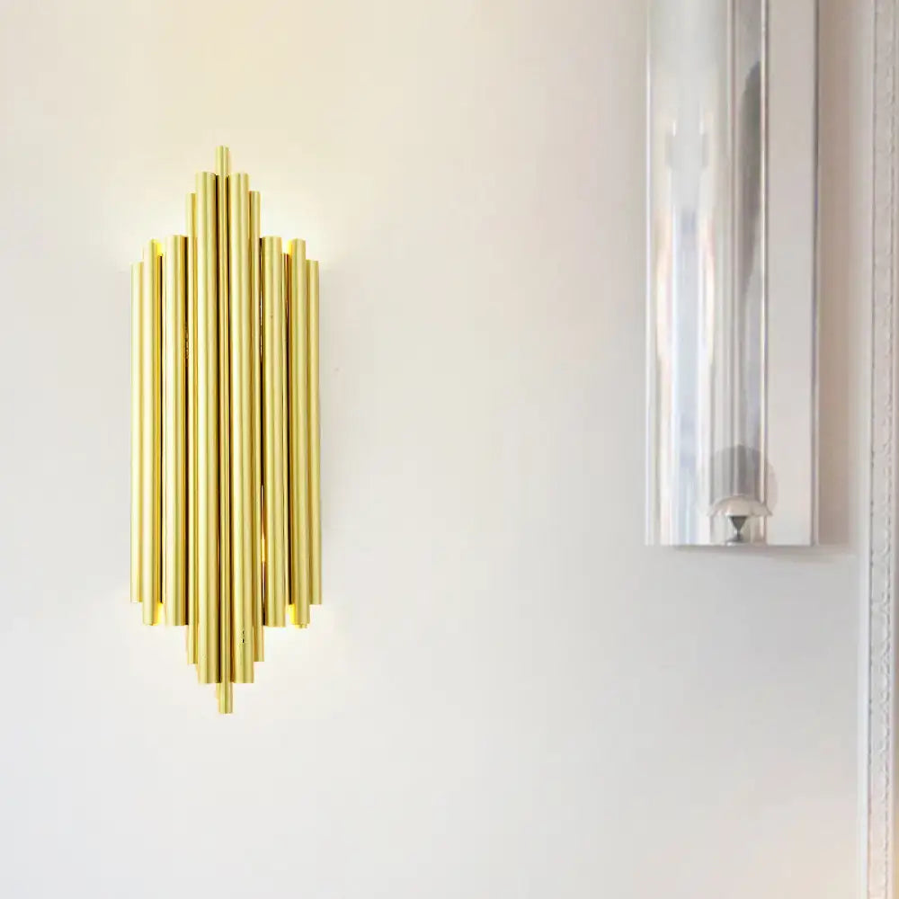 Gold Flute Wall Sconce by Decorbites gold-tone brass vertical rod design mounted on a light wall on Tampa Home & Garden Store