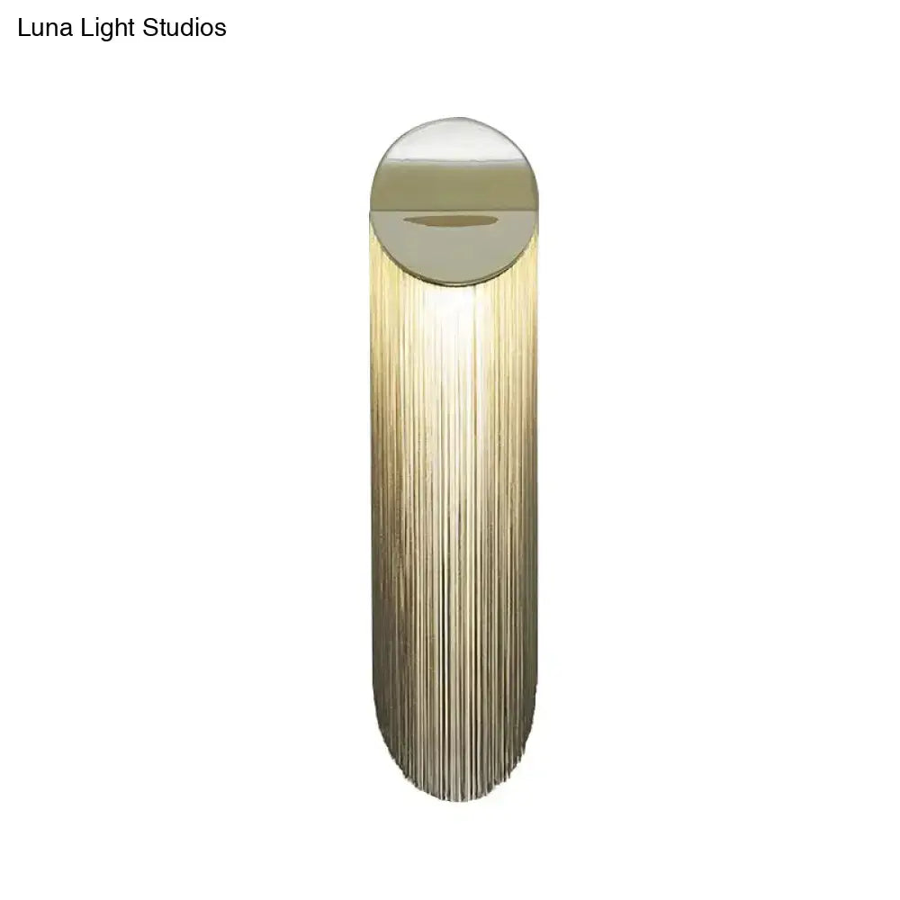 Gold fringed wall sconce with vertical metallic fringe tassels in warm brass Decorbites on Tampa Home & Garden Store