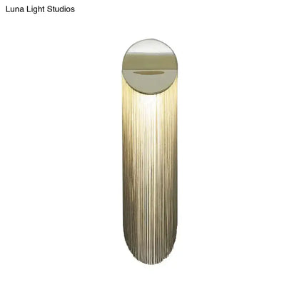 Gold fringed wall sconce with vertical metallic fringe tassels in warm brass Decorbites on Tampa Home & Garden Store