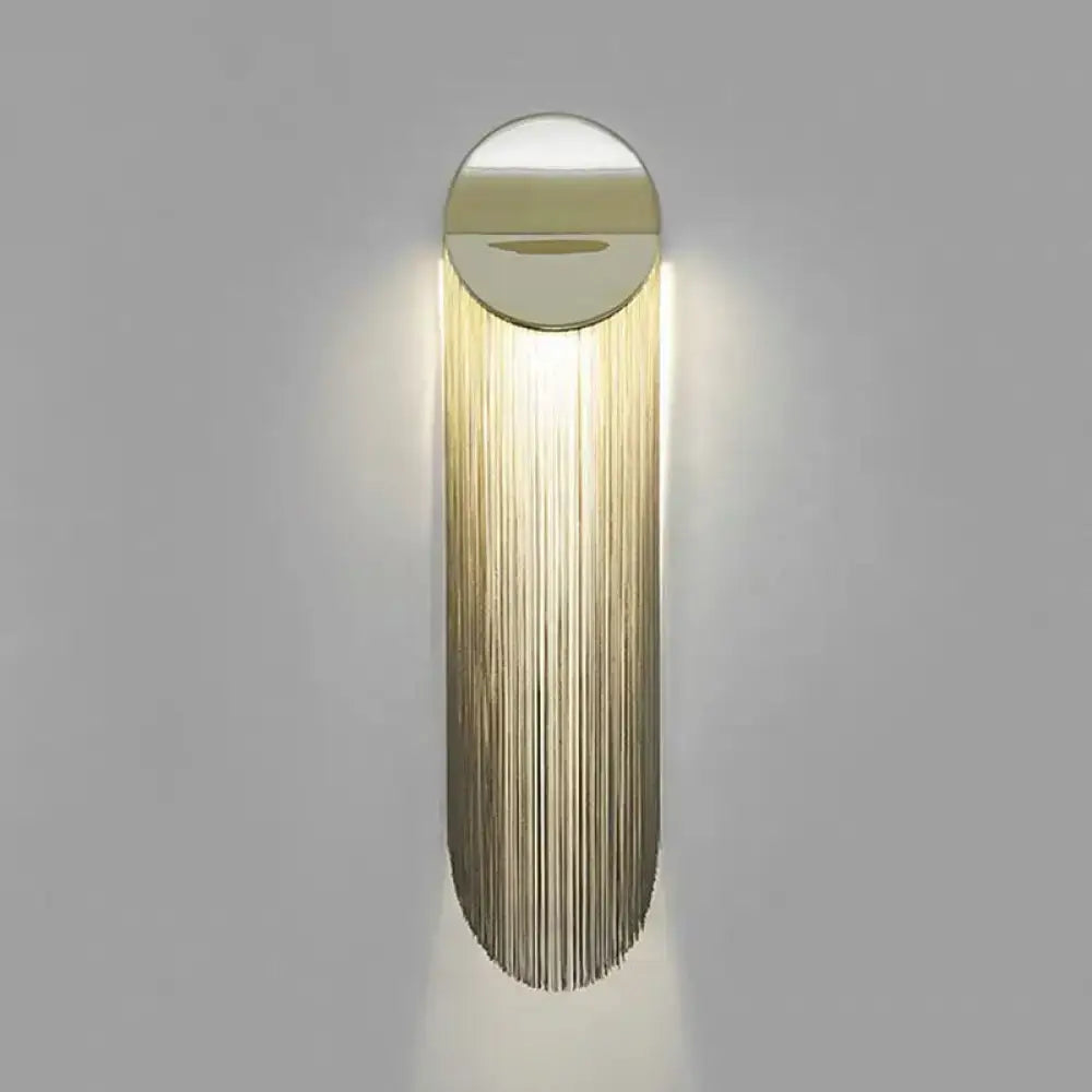 Gold fringed wall sconce by Decorbites with round mirrored cap and long metallic fringe on Tampa Home & Garden Store