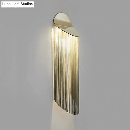 Gold Fringed Wall Sconce with curved gold backplate and long fringe drops by Decorbites on Tampa Home & Garden Store