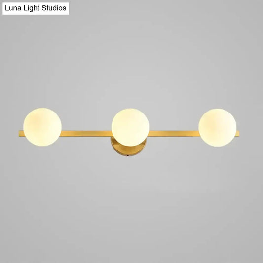 Postmodern gold glass globe wall sconce by Decorbites, brass bar, frosted globe trio, 11in on Tampa Home & Garden Store