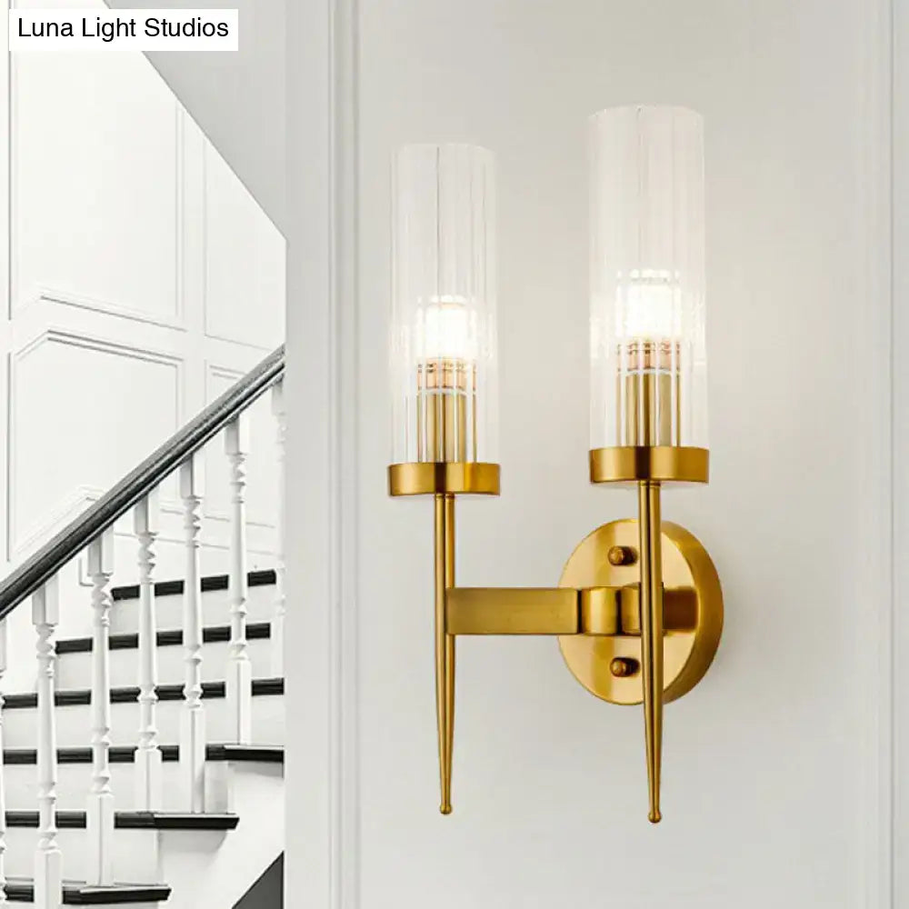 Decorbites gold ribbed glass stairway dual-light wall sconce with brass finish and twin cylindrical shades on Tampa Home & Garden Store
