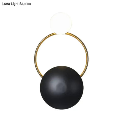 Black Gold Orb Wall Sconce featuring a gold ring with a matte black orb and white globe on Tampa Home & Garden Store