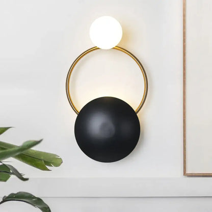 Black Gold Orb Wall Sconce by Decorbites; matte black orb with gold ring and white globe accent on Tampa Home & Garden Store