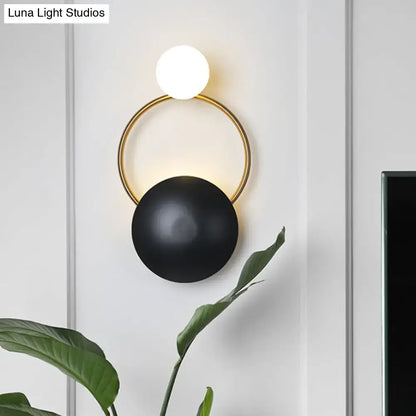 Black gold orb wall sconce with white globe top and black orb bottom on a gold ring on Tampa Home & Garden Store