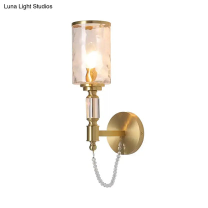 Brass crystal wall sconce with cylindrical glass shade and crystal chain Decorbites on Tampa Home & Garden Store