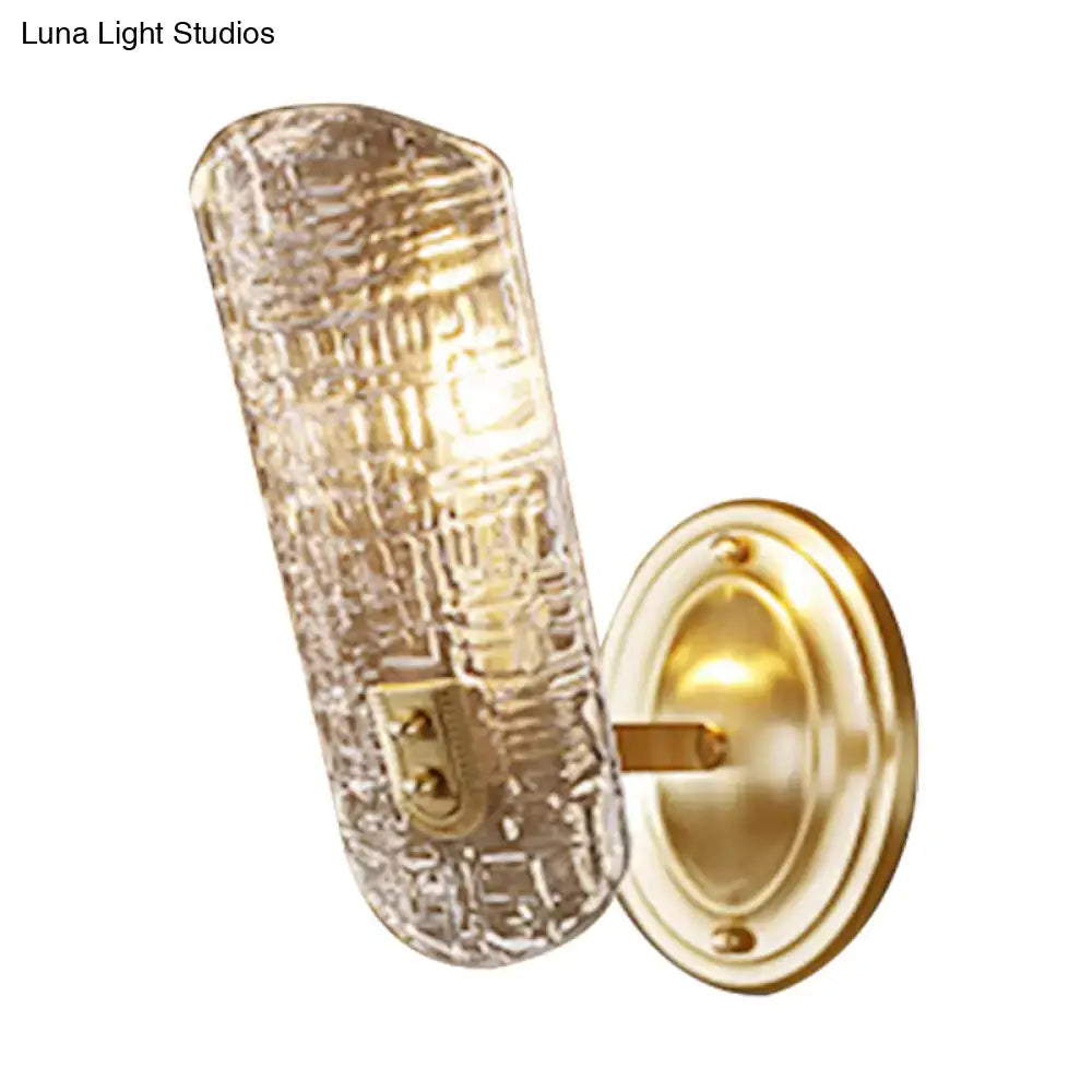 Gold prism glass wall sconce with textured glass shade and brass backplate on Tampa Home & Garden Store