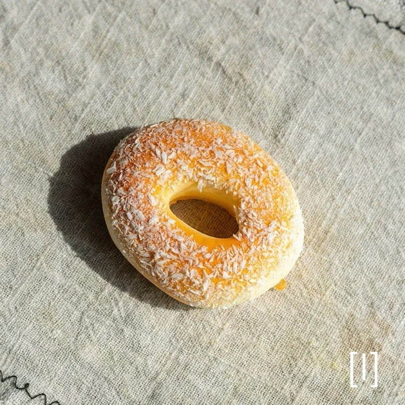 Artificial Bread & Pastry Display Prop bagel with coconut flakes on linen backdrop RusticReach on Tampa Home & Garden Store
