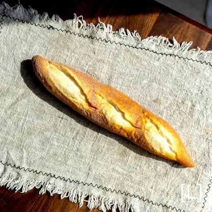 Artificial Bread & Pastry Display Prop baguette, RusticReach, crusty golden loaf on mat on Tampa Home & Garden Store