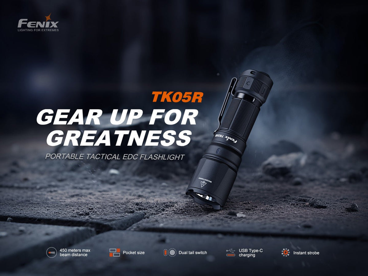 Fenix TK05R tactical EDC flashlight black aluminum with pocket clip angled on rocky ground on Tampa Home & Garden Store