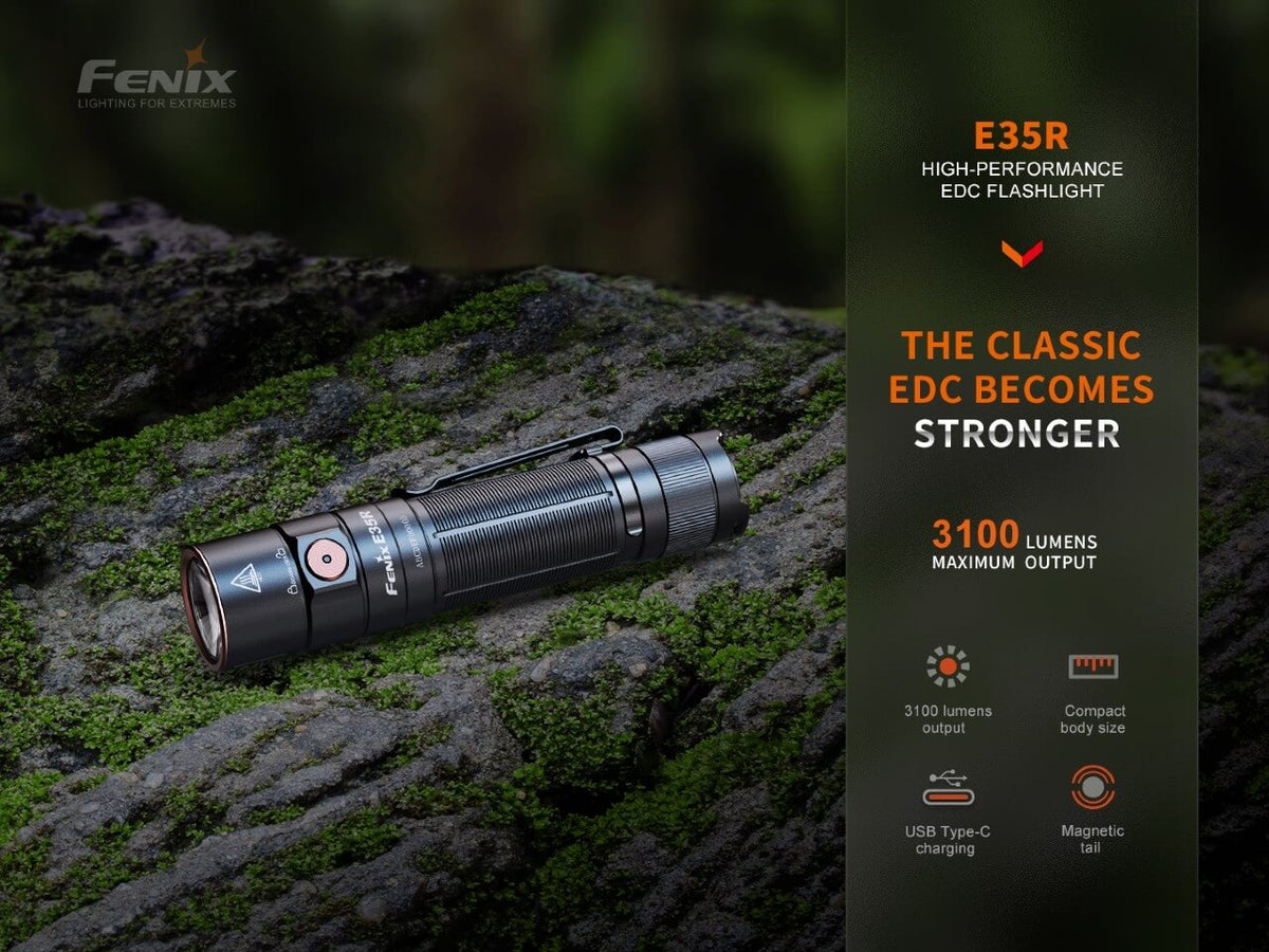 Fenix E35R EDC flashlight black aluminum with orange button on mossy rock on Tampa Home & Garden Store