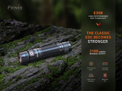 Fenix E35R EDC flashlight black aluminum with orange button on mossy rock on Tampa Home & Garden Store