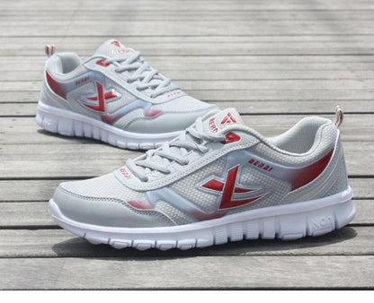 Stevvex men's running sneakers white breathable mesh with red accents pair on Tampa Home & Garden Store