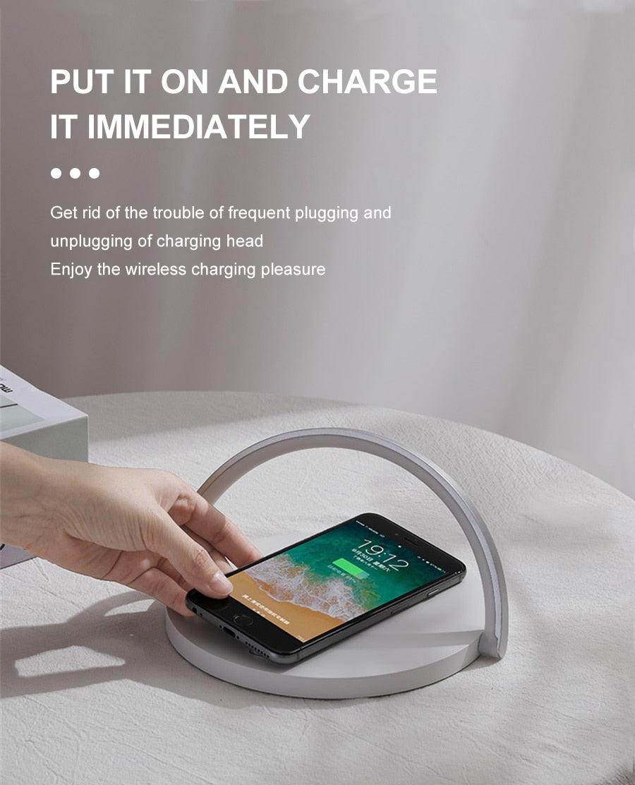 Wireless charger LED night light lamp from Stevvex with gray arc and phone charging on base on Tampa Home & Garden Store