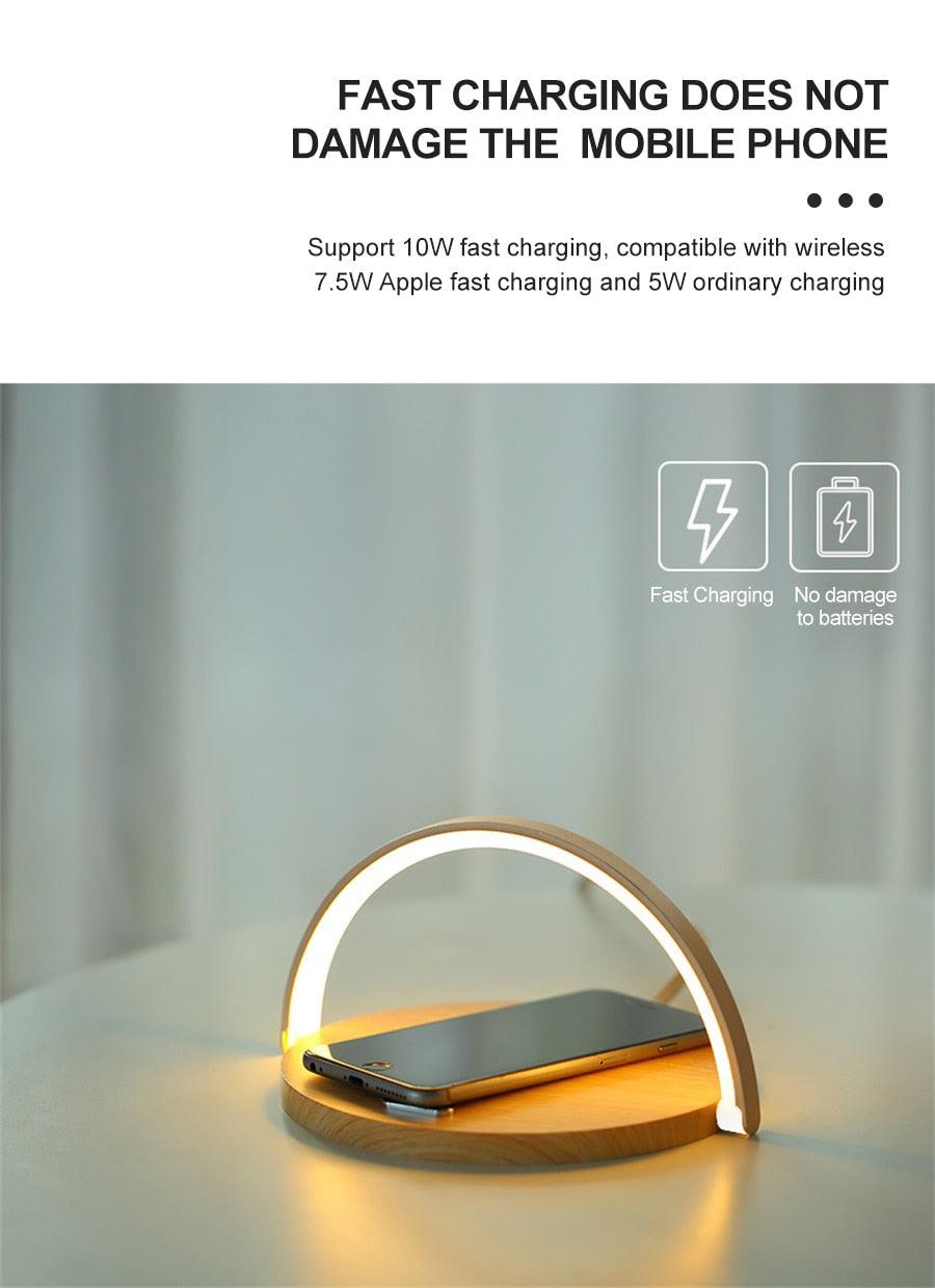 Stevvex wireless charging LED desk lamp with wooden arc and white ring, phone on base on Tampa Home & Garden Store