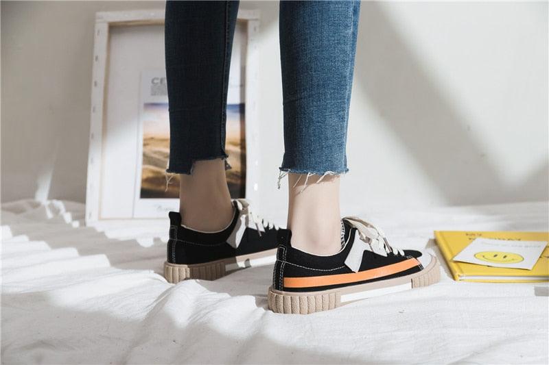 Stevvex women's canvas sneakers low-cut flats with black upper, laces and orange stripe sole on Tampa Home & Garden Store