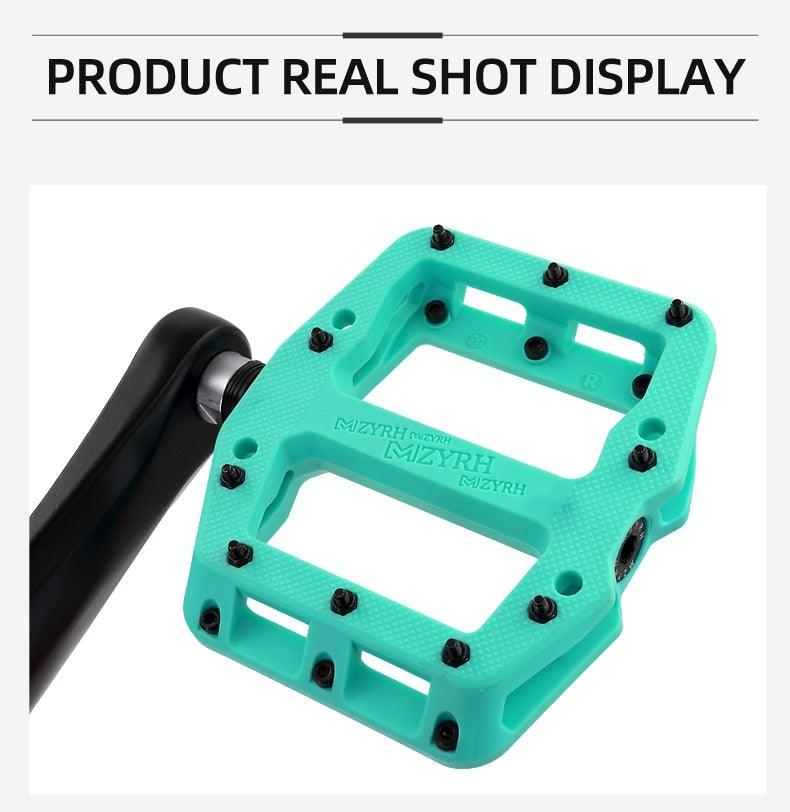 Turquoise flat platform bicycle pedal with black anti-slip pins and nylon body on Tampa Home & Garden Store