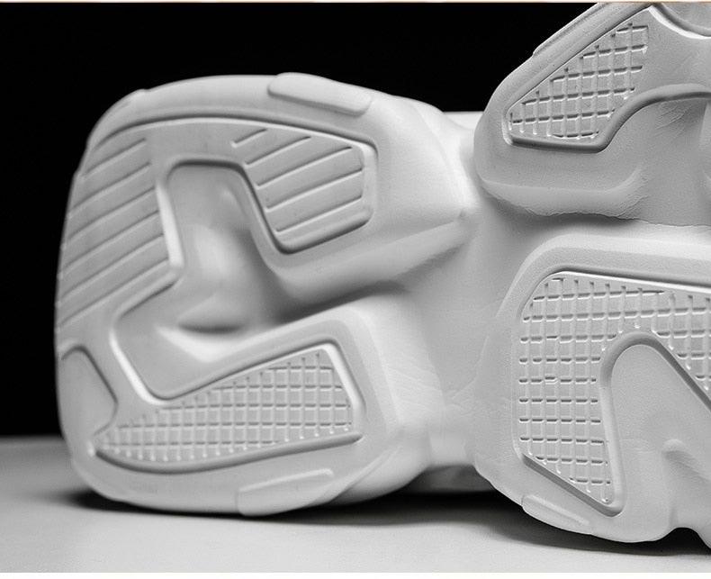 White chunky men's sneakers sole close-up with textured tread design on Tampa Home & Garden Store