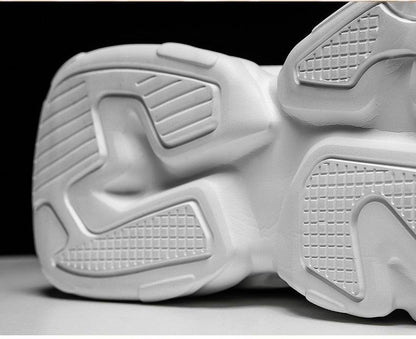 White chunky men's sneakers sole close-up with textured tread design on Tampa Home & Garden Store