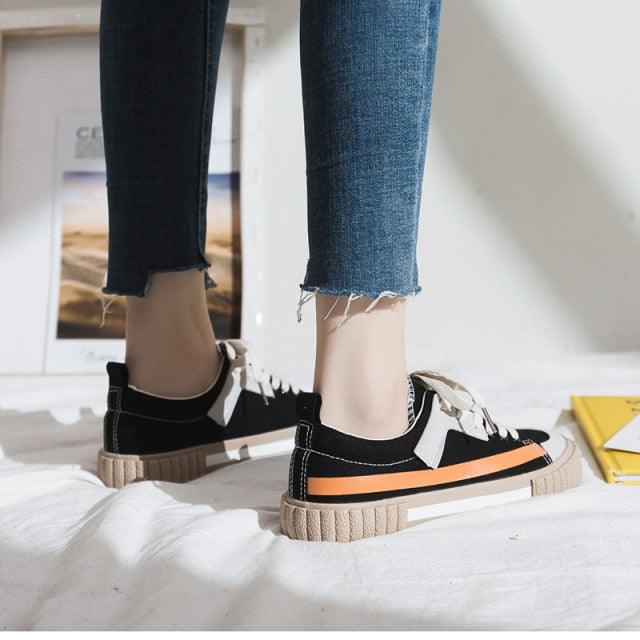 Stevvex women's canvas sneakers with black-white striped vulcanize design and orange sole stripe on Tampa Home & Garden Store