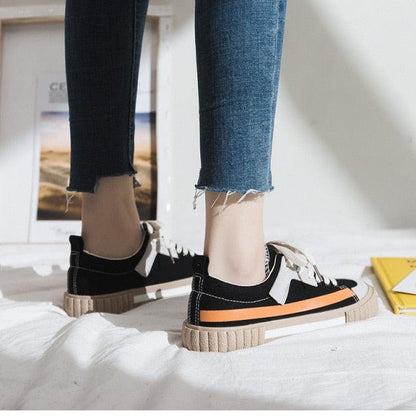 Stevvex women's canvas sneakers with black-white striped vulcanize design and orange sole stripe on Tampa Home & Garden Store