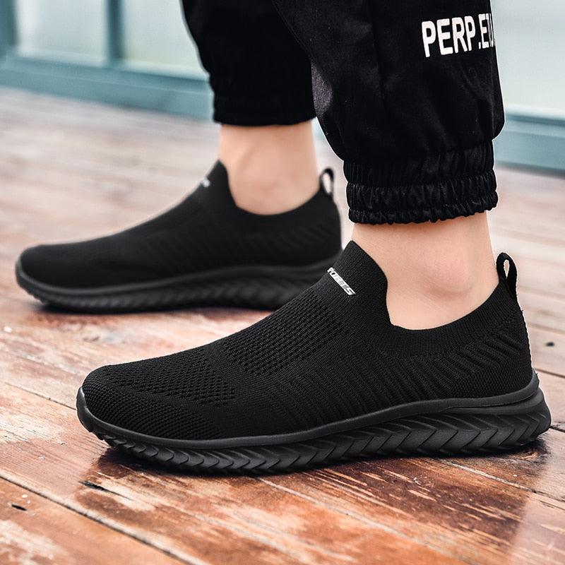 Stevvex slip-on sneakers, black knit upper with sock-like collar and textured sole, pair on Tampa Home & Garden Store