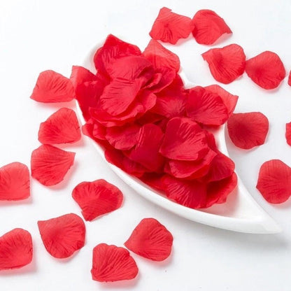 Artificial red rose petals Stevvex 1000pcs scattered on a white dish on Tampa Home & Garden Store