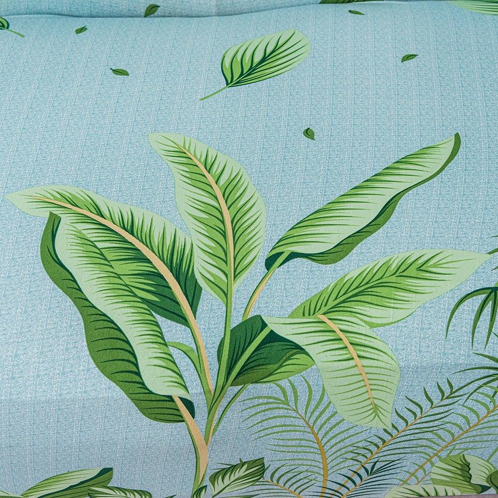 Elastic floral leaf print sofa cover with blue background and tropical green leaves on Tampa Home & Garden Store