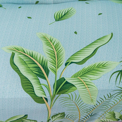 Elastic floral leaf print sofa cover with blue background and tropical green leaves on Tampa Home & Garden Store