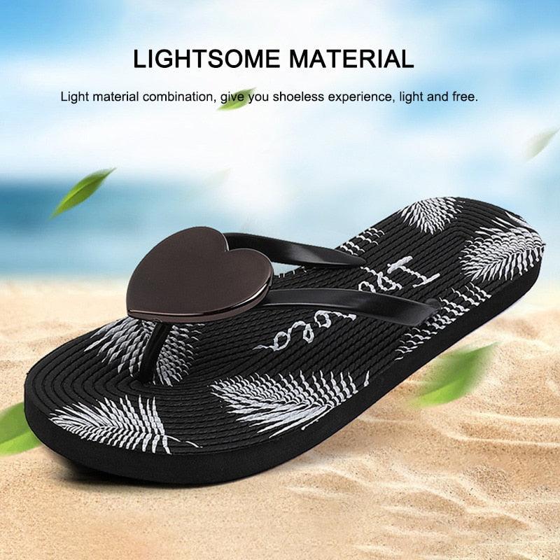 Stevvex black flip flops with heart-shaped thong and palm-leaf patterned sole on beach scene on Tampa Home & Garden Store