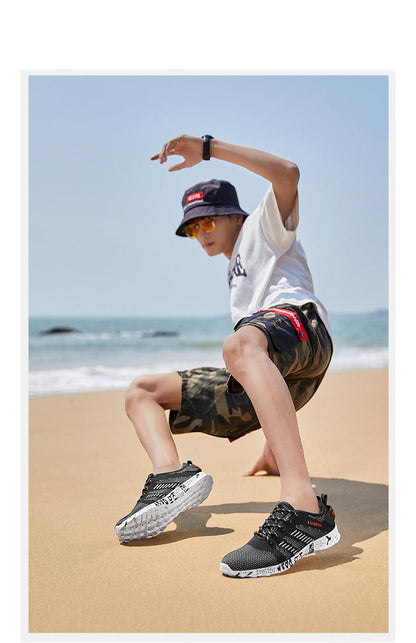 Stevvex Summer Sport sneakers black mesh upper with white patterned outsole worn on beach by man on Tampa Home & Garden Store