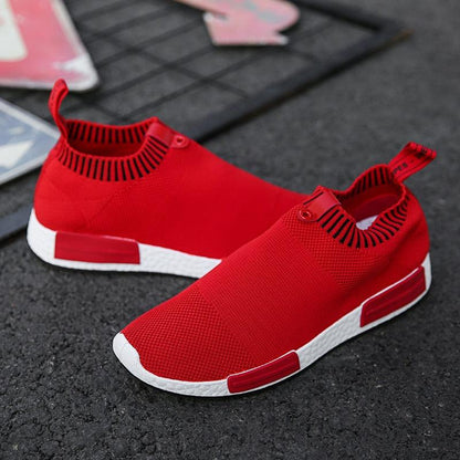 Men's red breathable slip-on running sneakers pair with white sole and mesh upper on Tampa Home & Garden Store