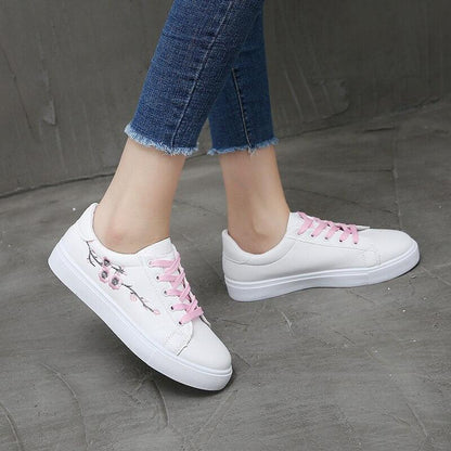 White PU leather platform sneakers pair by Stevvex with pink laces and floral embroidery on Tampa Home & Garden Store