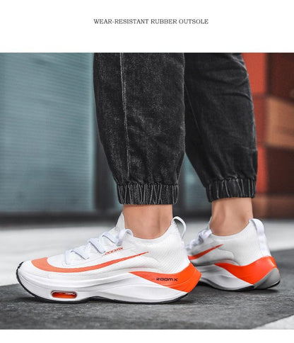 Stevvex mens white running sneakers with orange accents, breathable mesh upper, pair on Tampa Home & Garden Store