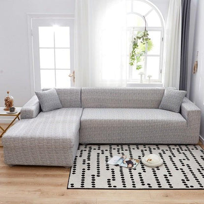 Stevvex elastic sofa cover for L-shaped sectional in light gray fabric with cushions on Tampa Home & Garden Store
