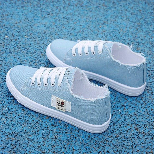 Light blue canvas sneakers with white laces, frayed edges, Stevvex logo patch, pair on Tampa Home & Garden Store