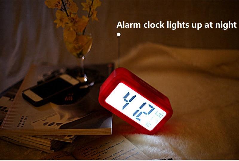 Stevvex red digital alarm clock with LED display on a bed beside magazines on Tampa Home & Garden Store