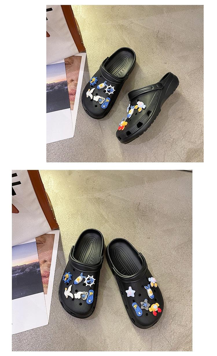 Stevvex black slip-on garden sandals with colorful nautical charms, pair shown on floor on Tampa Home & Garden Store