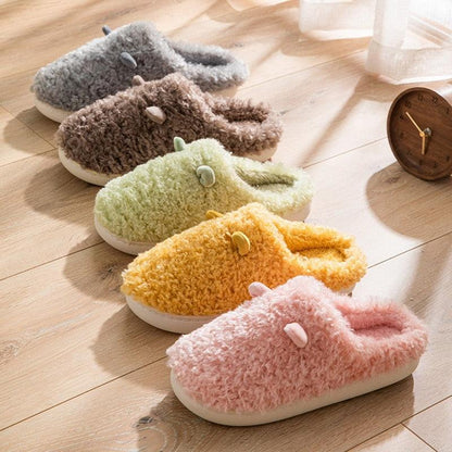 Fluffy faux fur house slippers, five color variants with white soles and button accents on Tampa Home & Garden Store