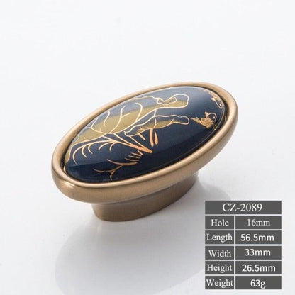 Navy blue ceramic door knob with gold botanical design on bronze base on Tampa Home & Garden Store
