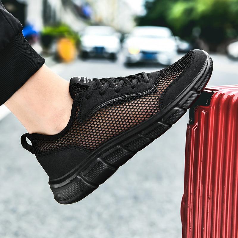 Stevvex men's black sneakers with breathable mesh upper and cushioned sole on foot on Tampa Home & Garden Store